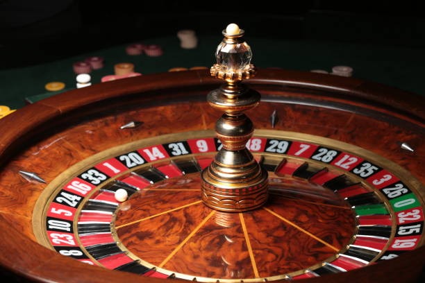 Live roulette table at alexs studio with Bundesliga on monitor in background